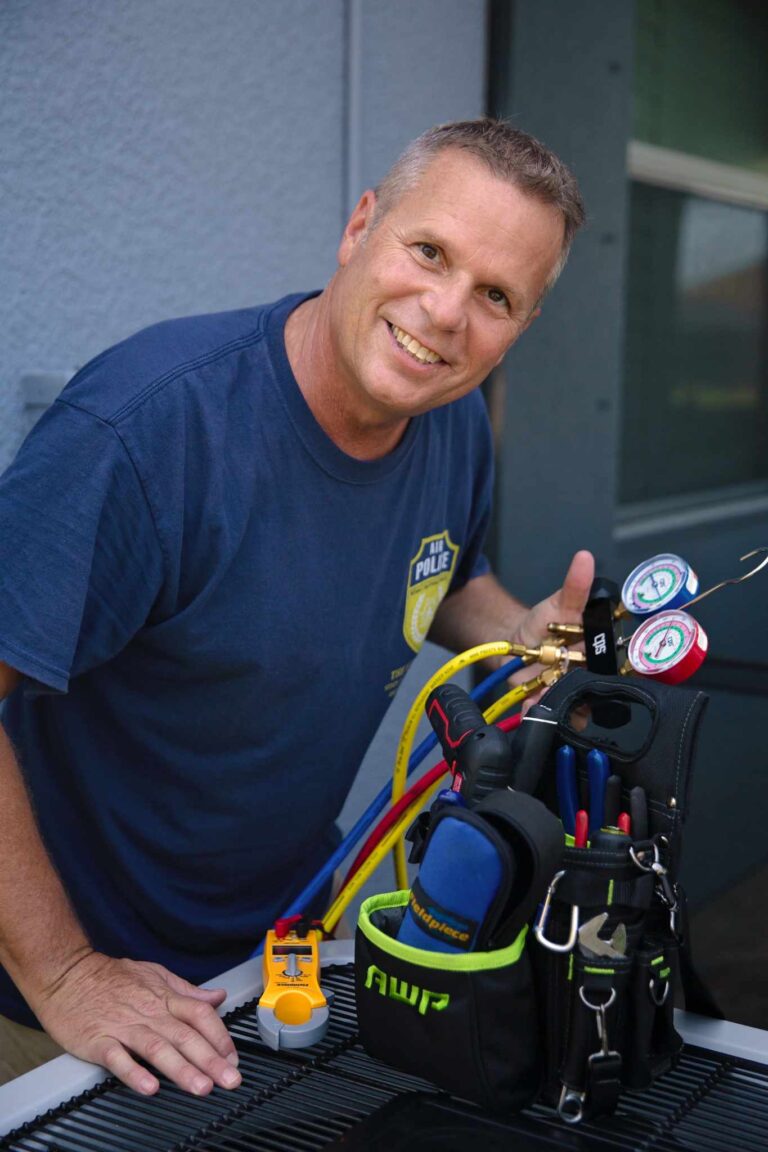 Air Police HVAC owner smiling and standing in front of the company office, representing dedication to customer service and quality HVAC solutions.